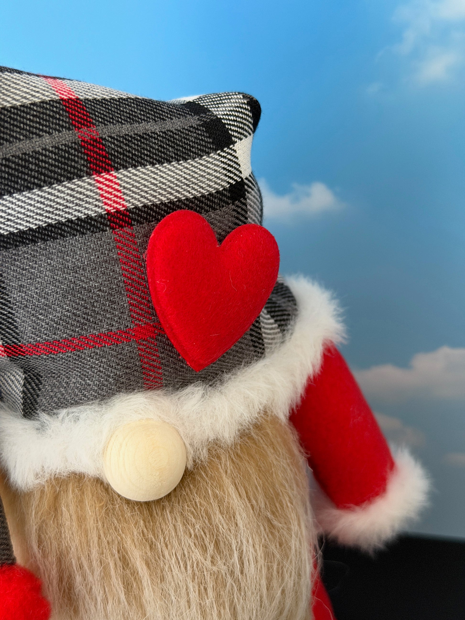 Close-up of gnome details including tartan hat, faux fur trim, heart-shaped nose and character beard. Handmade by Northern Nomes